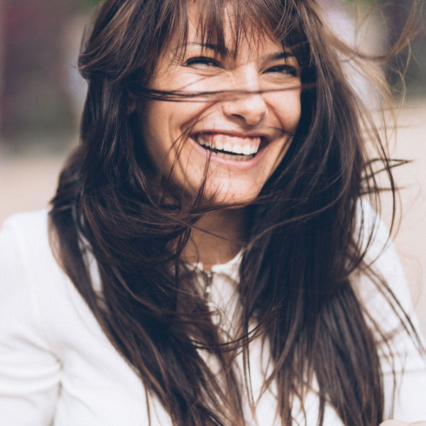 A woman in Norton Shores, MI, happy after a quick & painless dental sealant process