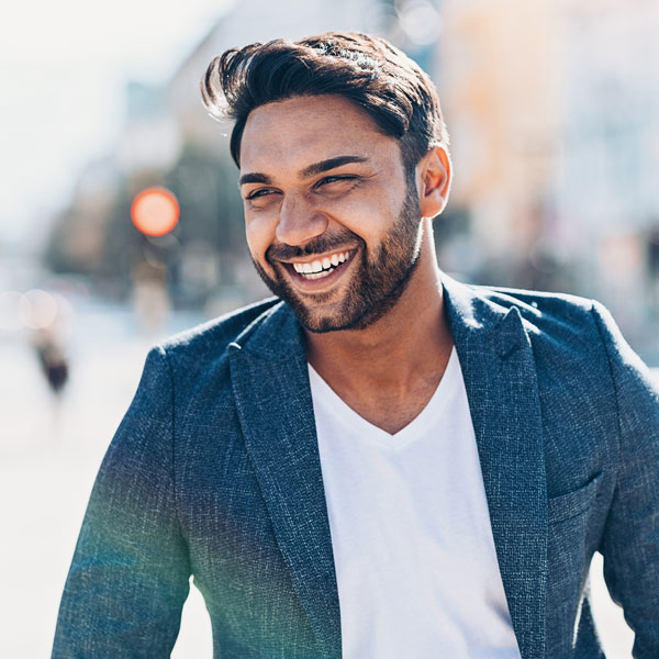 man in blue suit smiling