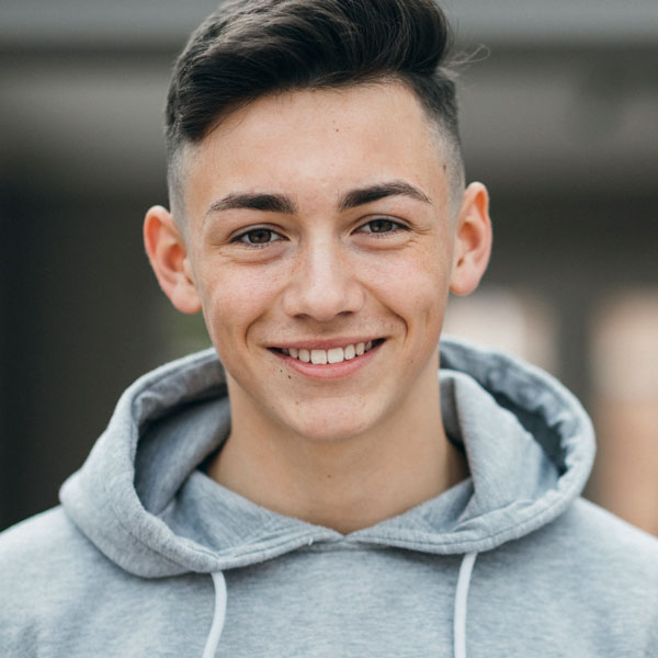 Boy smiling with a dental bridge in Norton Shores, MI