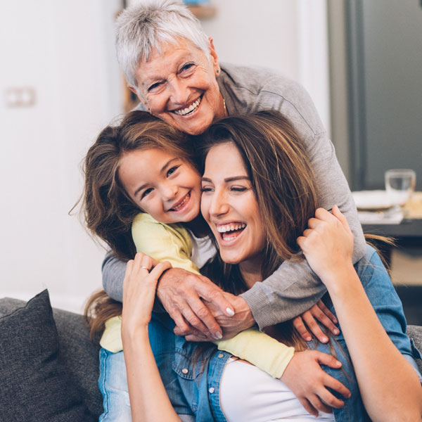 A woman and two children sitting together on a couch in Phoenix, AZ